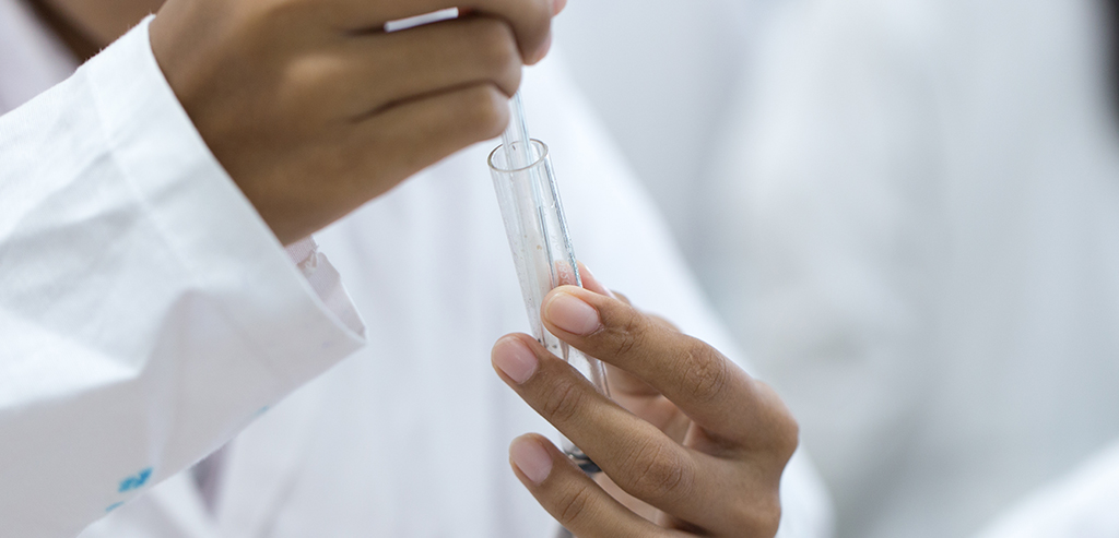 lab worker holding test tube